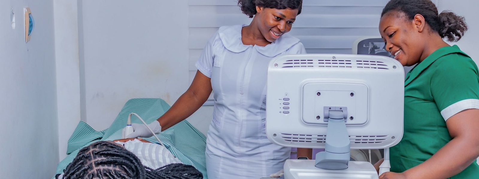Clinicians performing an ultrasound scan at an outpatient clinic