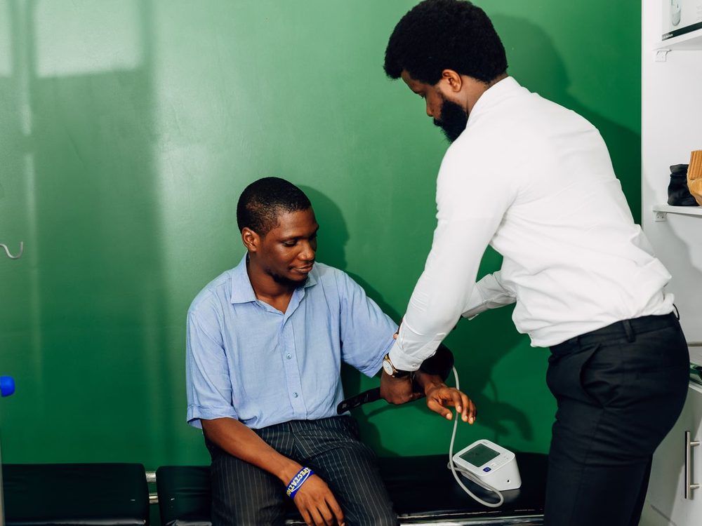 Clinician taking a patient's blood pressure during a consultation